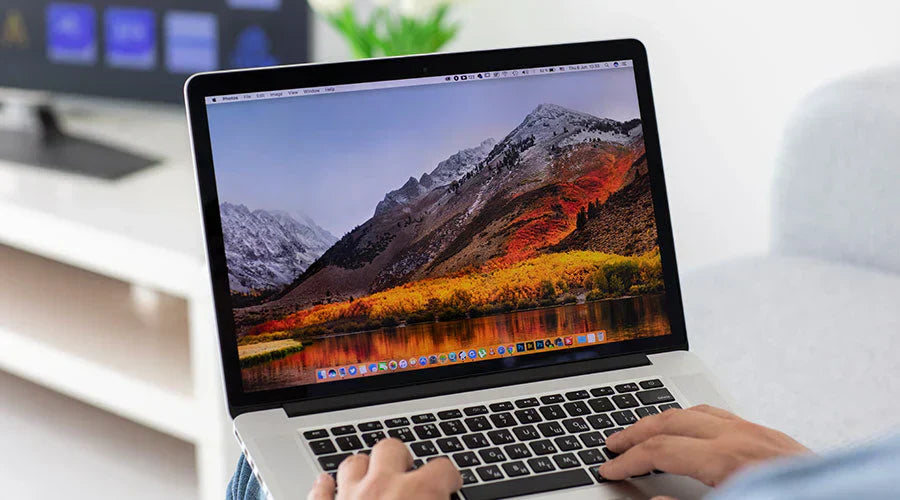Customer reviewing MacBook Pro before purchase at PayMore Clinton